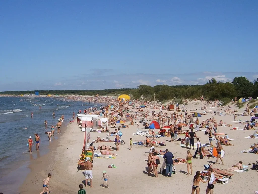 Busy summer beach in Palanga with sunbathers, dunes and the Baltic Sea