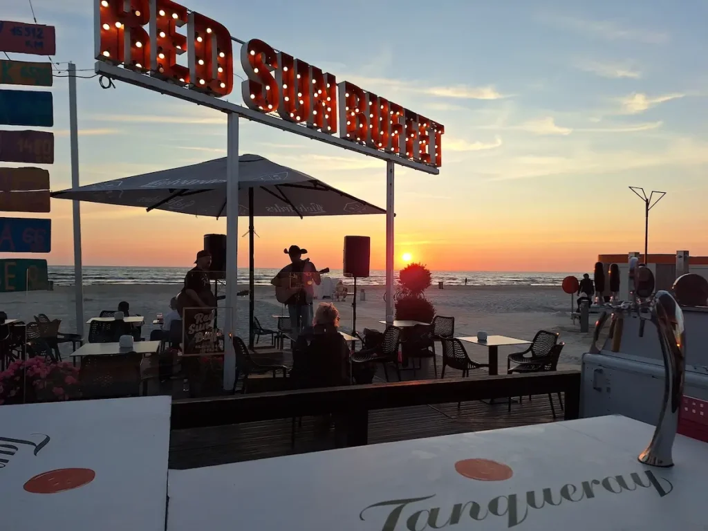Sun Red Buffet beach bar on Liepāja Beach at sunset with tables facing the Baltic Sea showing plenty of things to do in liepaja in the summer
