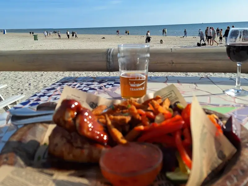 liepaja beach at sunset with the sun reflecting off the baltic sea and golden sands