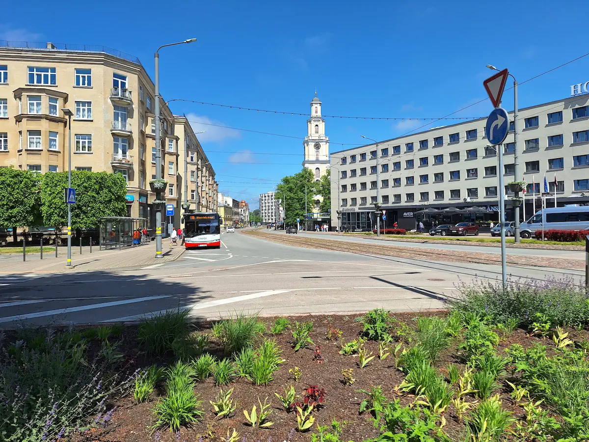 where to stay in liepaja centre Liepāja city centre with Līva Hotel, tram tracks, and Holy Trinity Cathedral in the distance.