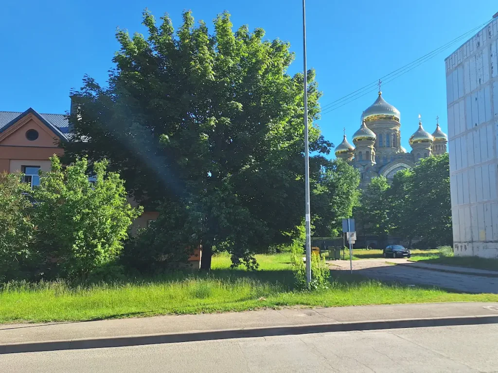 St Nicholas Naval Cathedral partly hidden behind trees and Soviet-era housing in Karosta